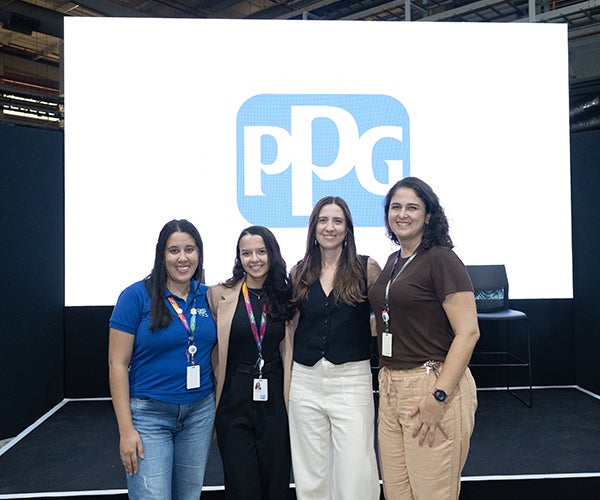 Female colleagues in front of PPG screen smiling