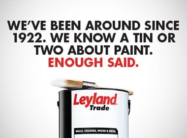 A paint can with a brush on top