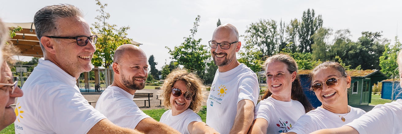 Group of volunteers smiling at Colorful Communities project