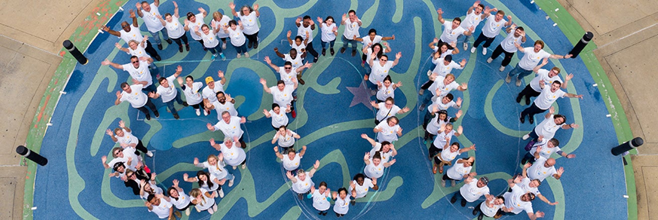 PPG volunteers celebrating 500th Colorful Communities project forming large number 500