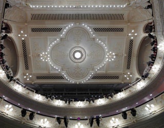 High-angle view of a theatre ceiling with ornate decorative details.