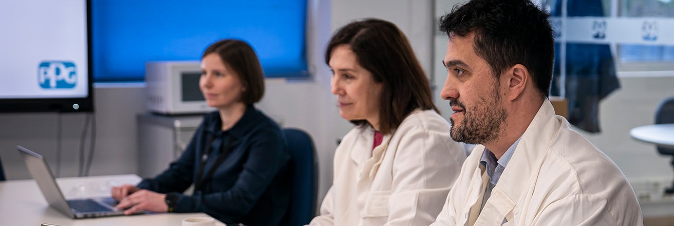 Three PPG employees listening to discussion