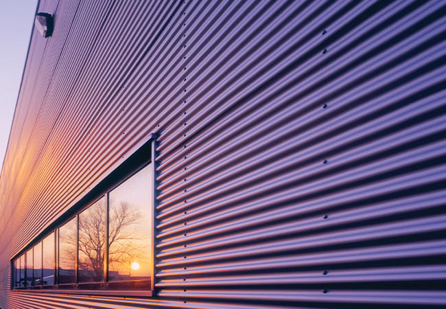 Violet Coil Warehouse with glass front reflecting the sun going down