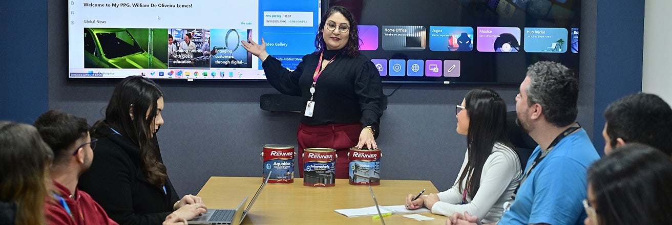 Female leading presentation in front of meeting room of people