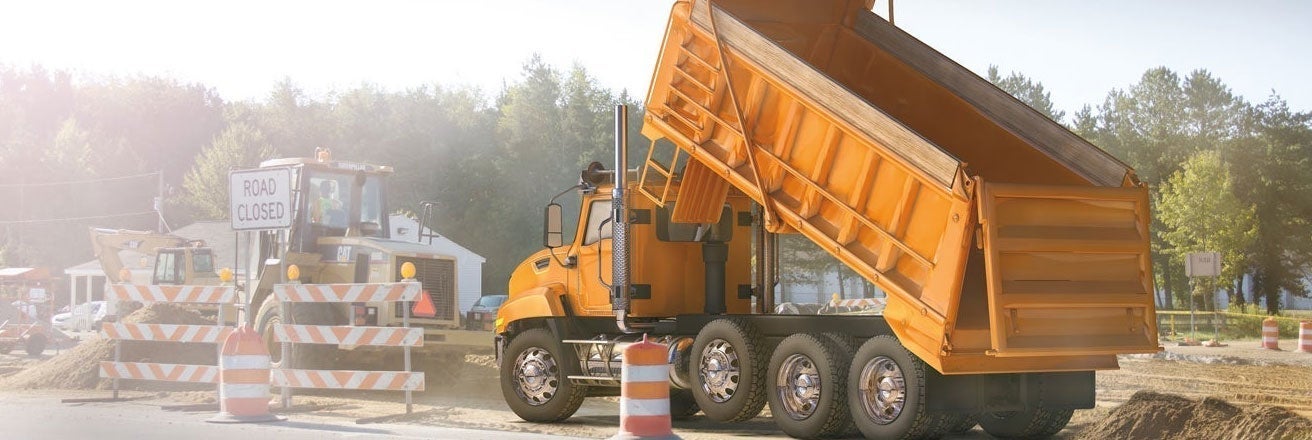 Tipper truck emptying load on site