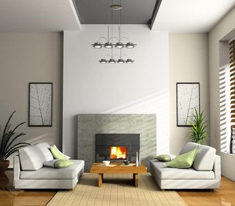 A living room with white furniture and a fireplace