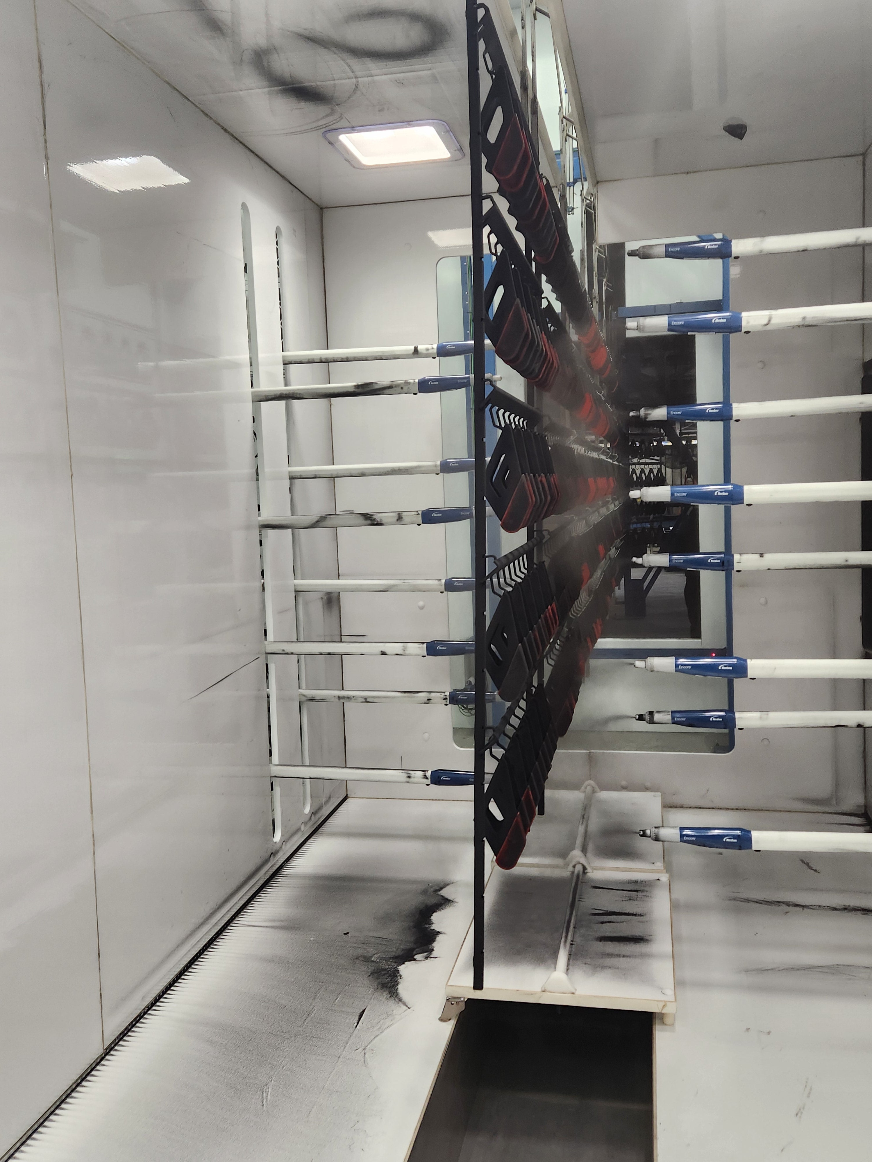 Powder booth coating parts for an OEM