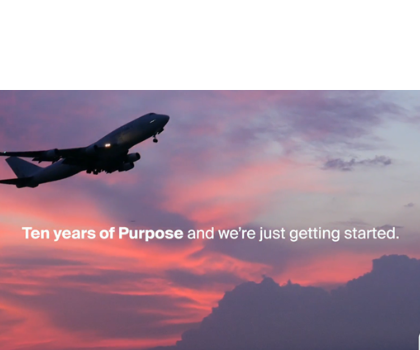 A plane in the sky with the words "Ten years of Purpose and we're just getting started"