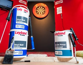 Leyland paint cans near darts.