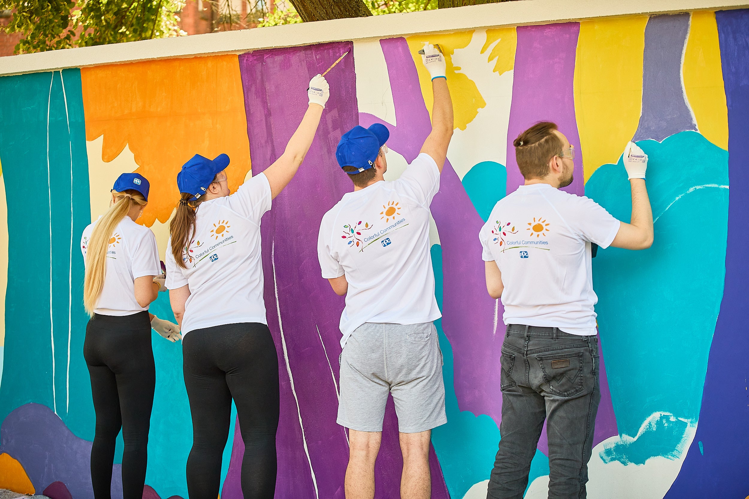 A group of people painting a wall