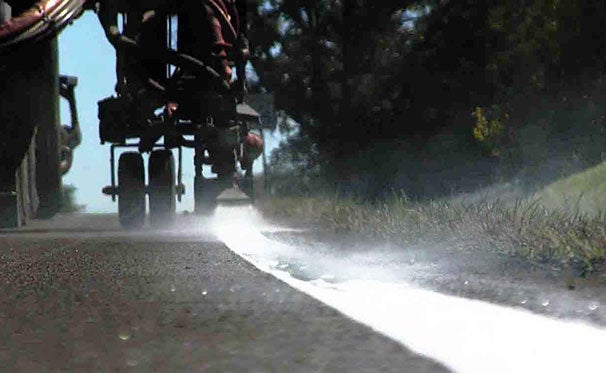 Truck applying markings to pavement