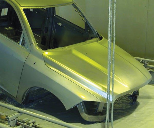 Car being electrocoated in assembly line