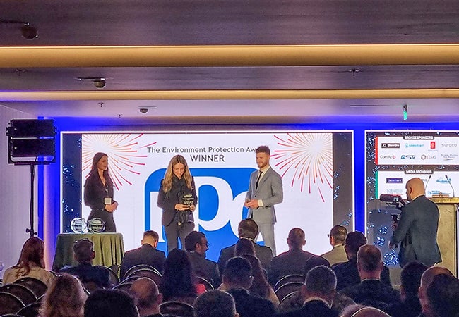 Ariana Psomas, a PPG employee, accepts the Environment Protection Award at a conference