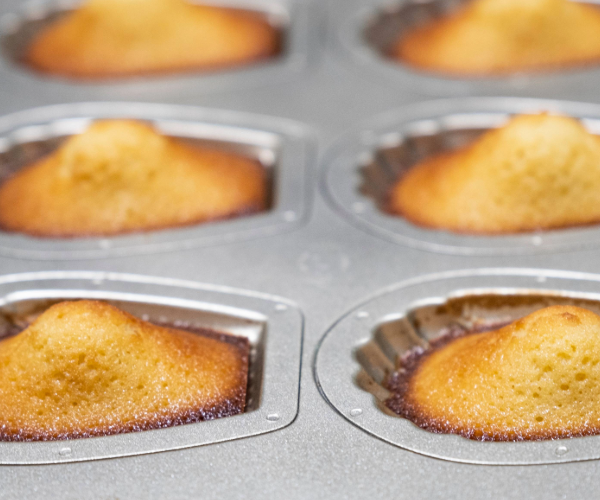Silver cake trays with buns being baked