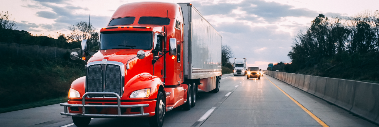 Red tractor trailer body on open road
