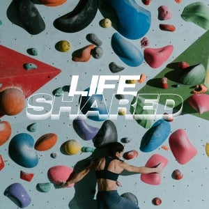 A woman climbing a rock wall