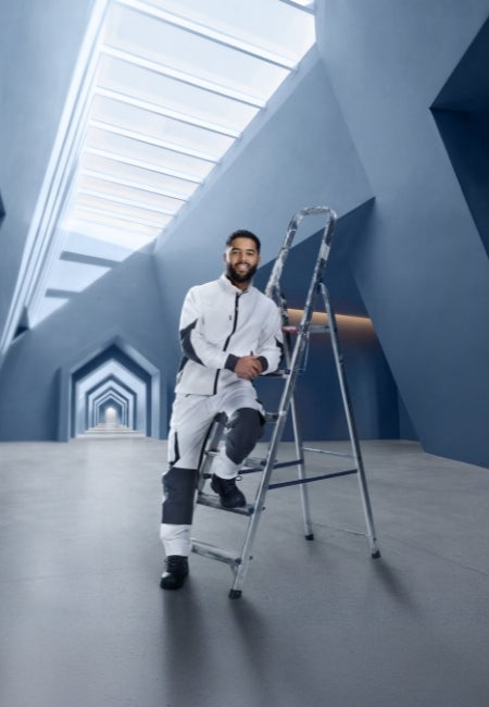 A man sitting on a ladder