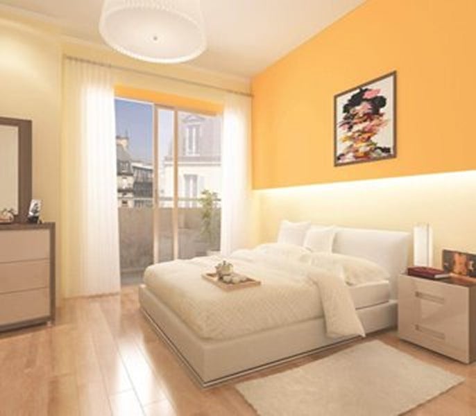 A bedroom with a bed and a dresser