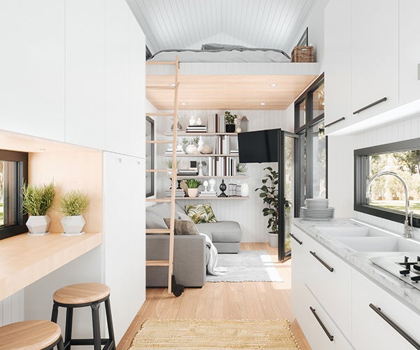 Internal view of a modern motor home displaying bright white fittings leading through to a seating area