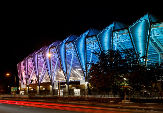 A stadium with blue lights at night