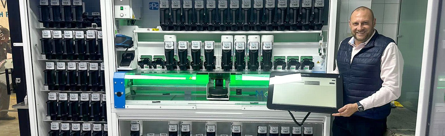 Julio Bueno, a PPG employee within our Automotive Refinish Coatings business, next to the PPG MoonWalk paint mixing machine