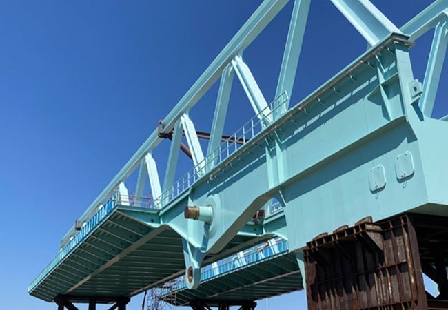 A blue bridge with metal beams