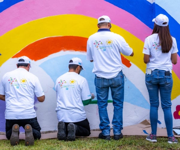 A group of people painting a rainbow