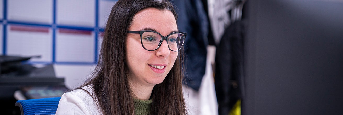 Female PPG employee working on computer