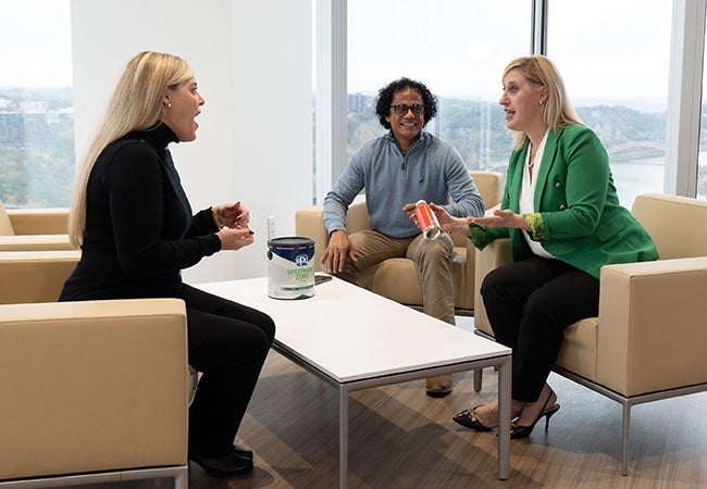 Three PPG employees discussing products