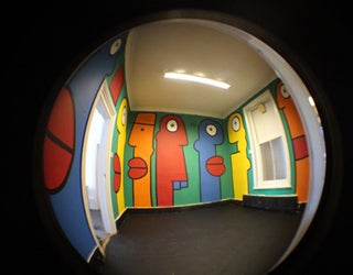 A room with an abstract-style mural, viewed through a fisheye lens
