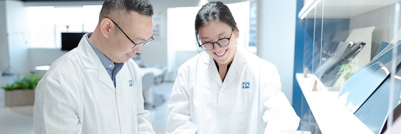 Two colleagues discussing whilst smiling