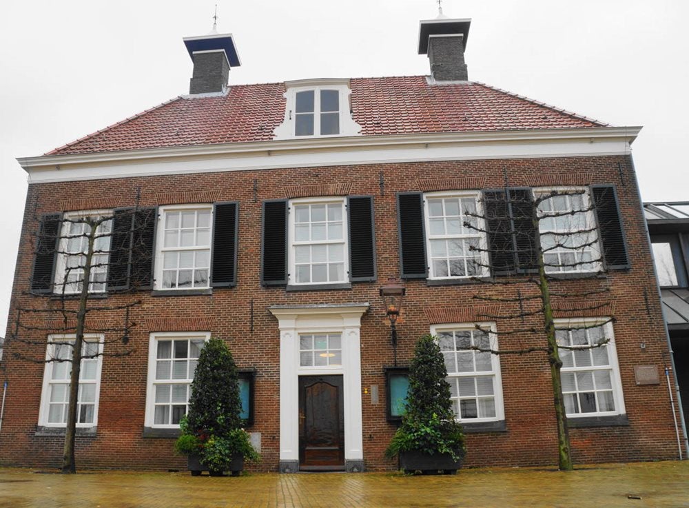 Een bakstenen gebouw met een bakstenen muur en een bakstenen looppad