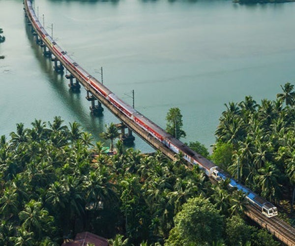 Train travelling over bridge across large river