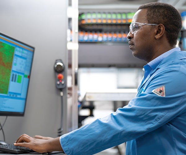 Male PPG worker using computer screen in lab