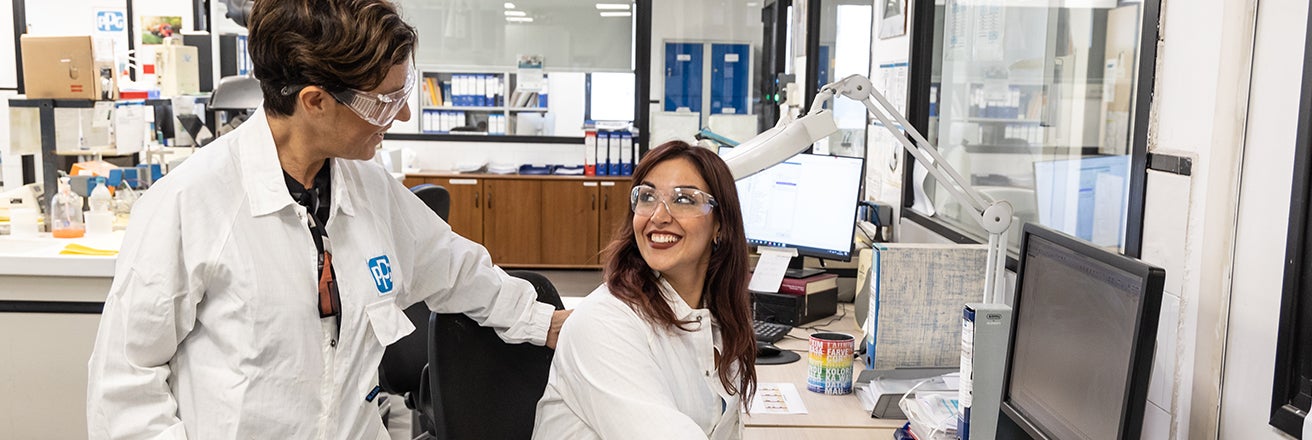Two female workers wearing PPE in laboratory