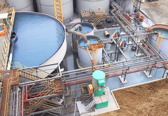 A large industrial plant with water tanks and pipes
