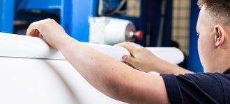 man rolling material