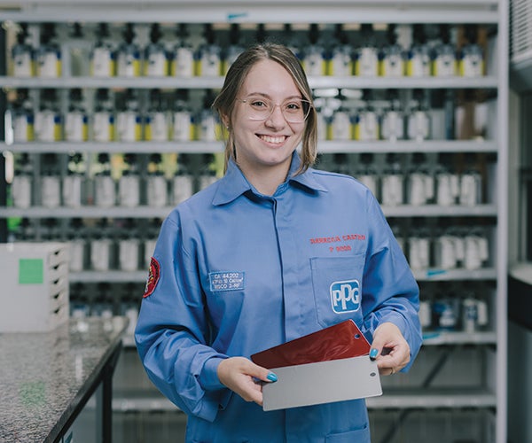 Female PPG worker holding color swatches