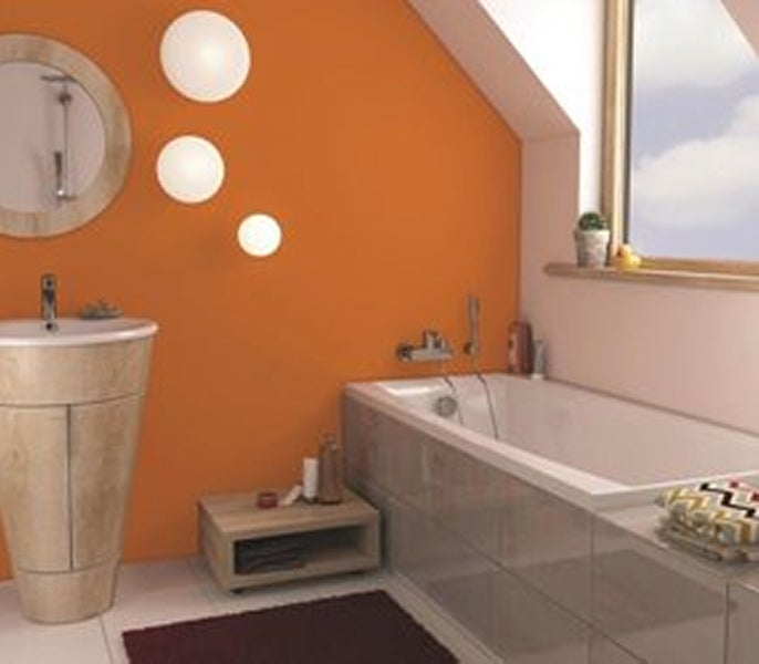 A bathroom with orange walls