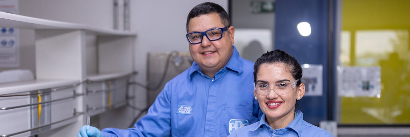 Two PPG workers in lab wearing PPE