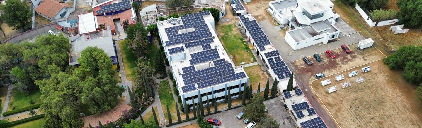 Aerial shot of building with solar panels covering roof