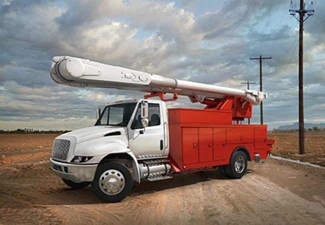 Red and white truck parked on track