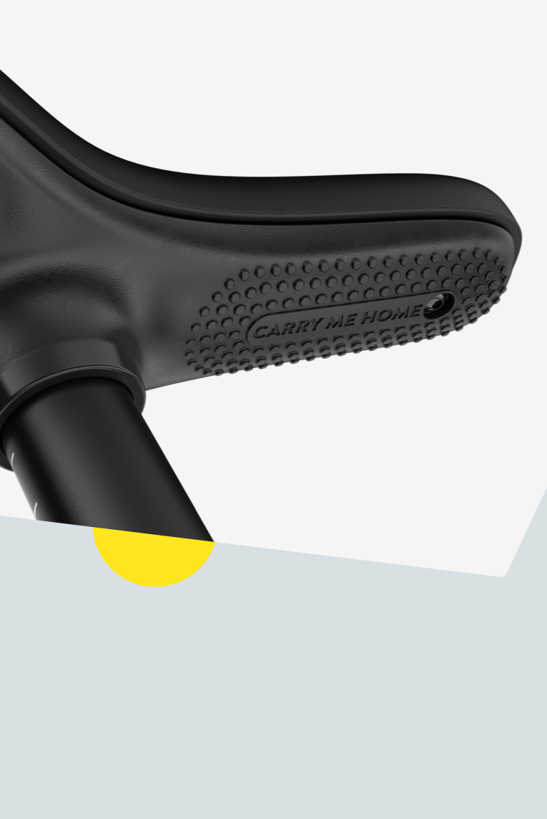 Close-up of the textured underside of the black saddle on a woom GO balance bike
