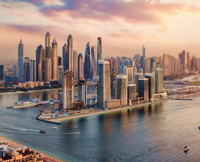 A city skyline with water and boats