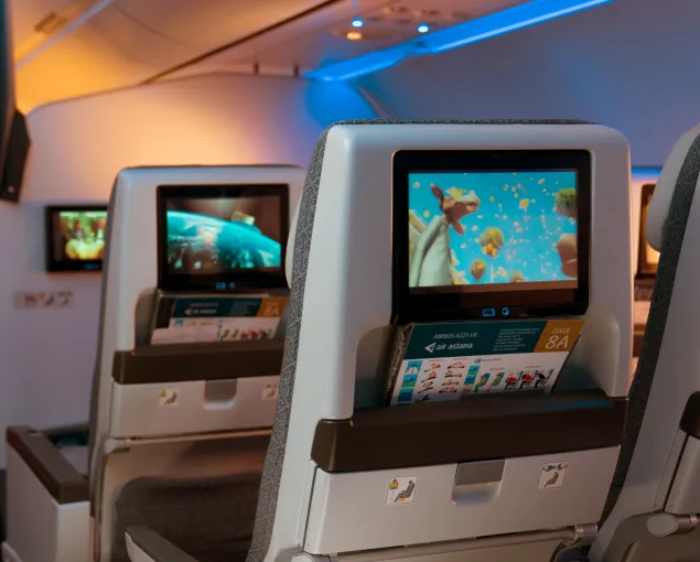 A row of seats with monitors on the side