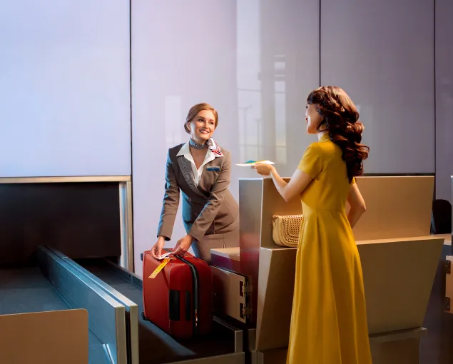A woman standing next to a woman holding a suitcase