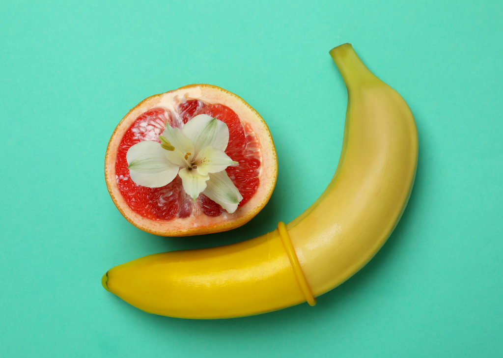A banana and grapefruit with a flower on it