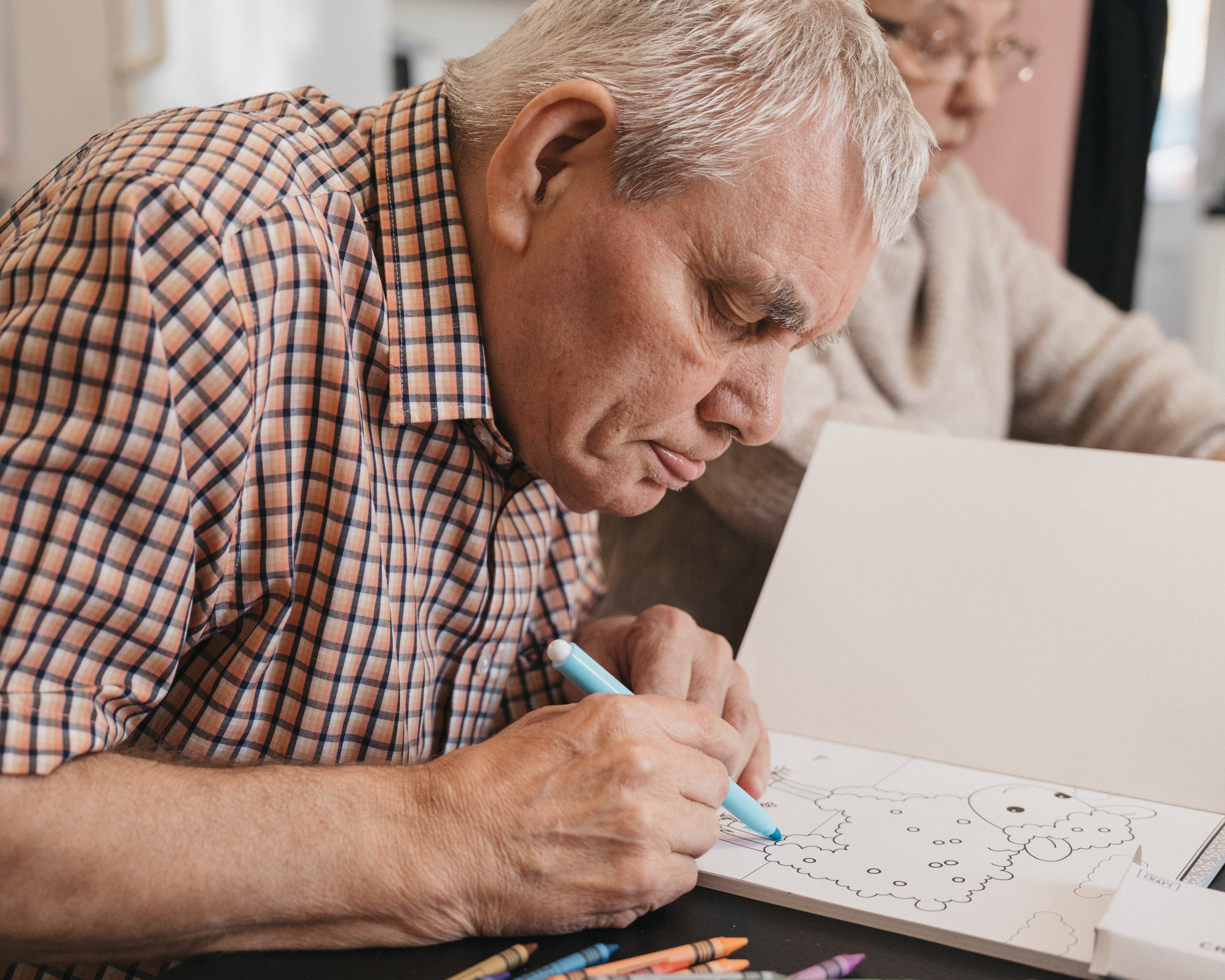 A man coloring a book