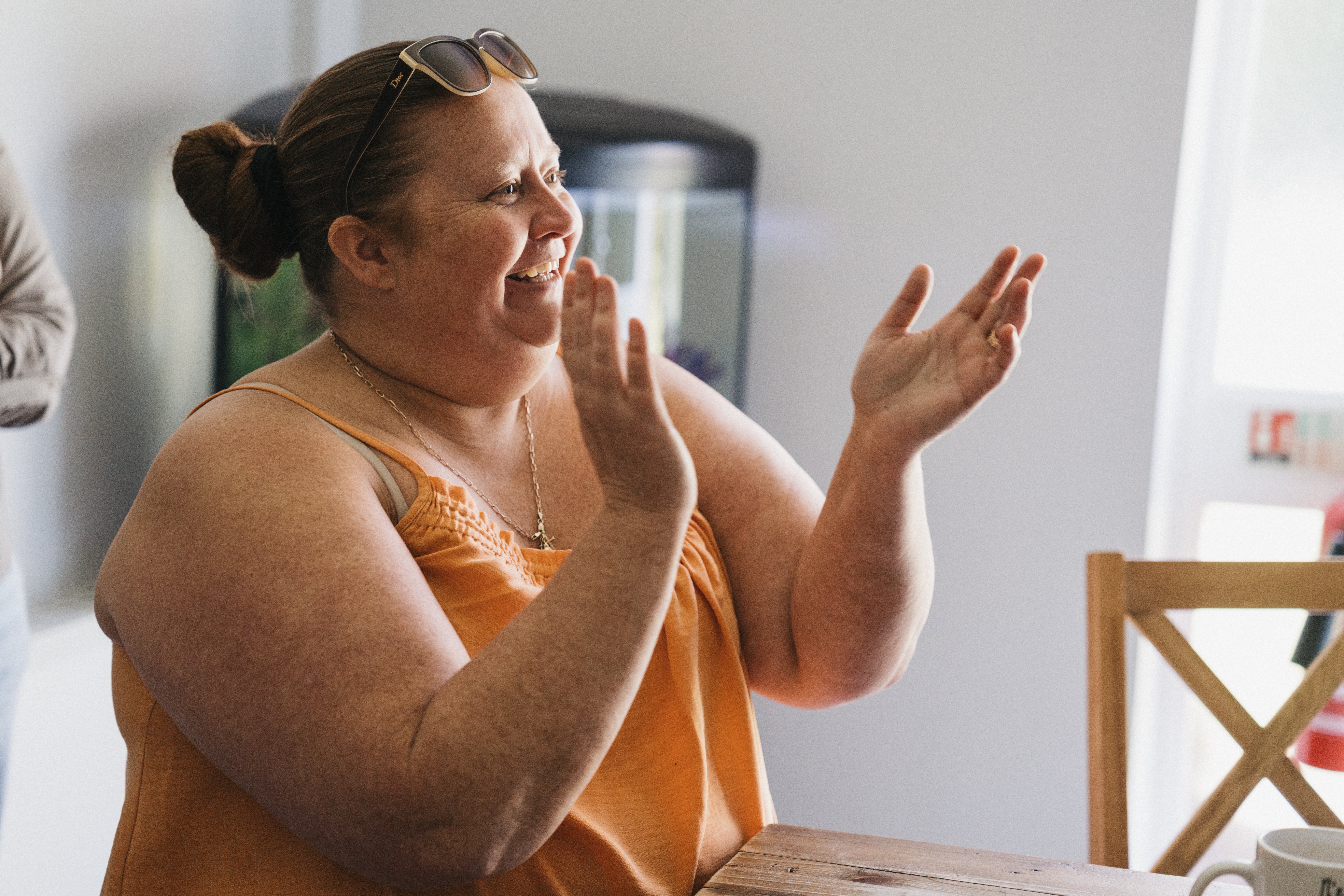 A lady smiling and clapping