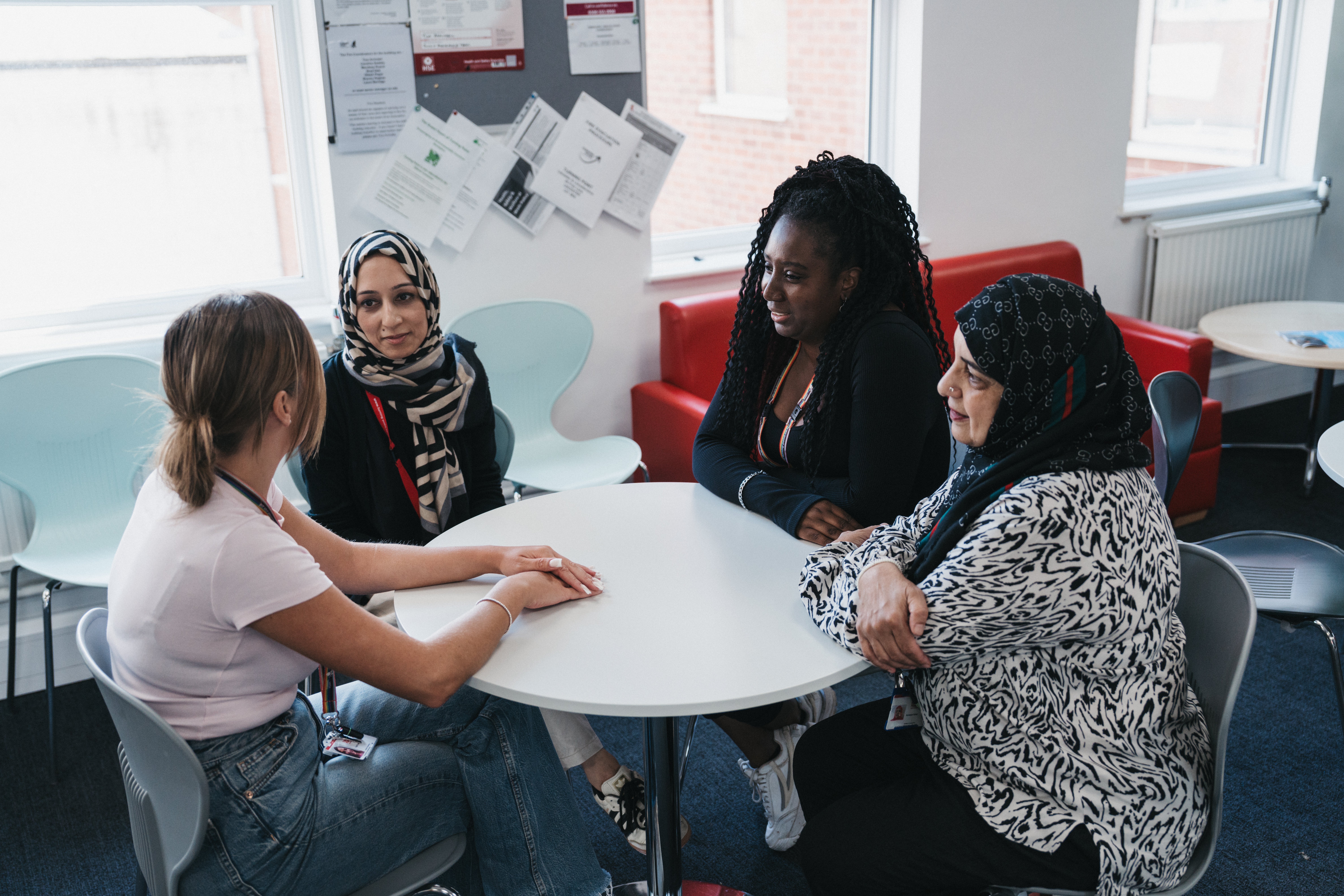 Four ladies sitting around a small round table